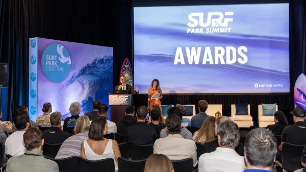 A large room with speakers and "Surf Park Awards" on a screen.