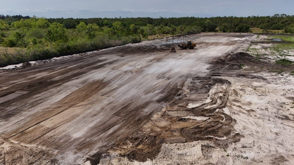 An empty field where construction is taking place on a Florida surf park.