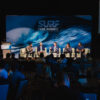 Surf Park Summit panel on stage in front of the logo