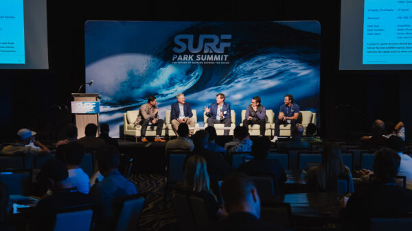 Surf Park Summit panel on stage in front of the logo